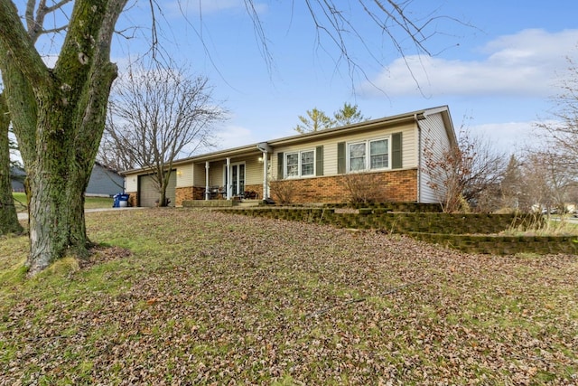 single story home featuring a garage, a front lawn, and a porch