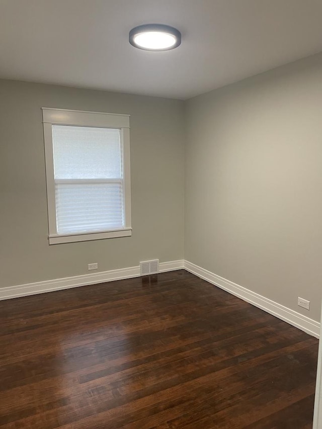 unfurnished room with dark hardwood / wood-style floors