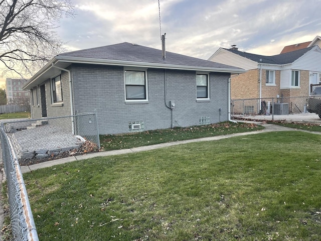 view of property exterior with a yard and central AC