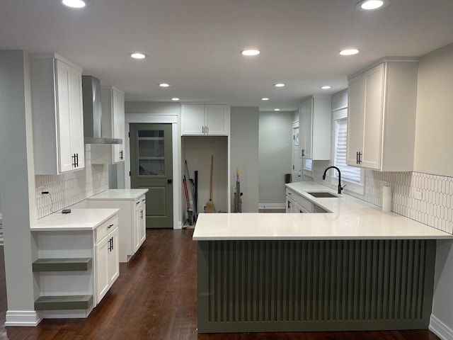 kitchen with decorative backsplash, wall chimney exhaust hood, sink, dark hardwood / wood-style floors, and white cabinetry