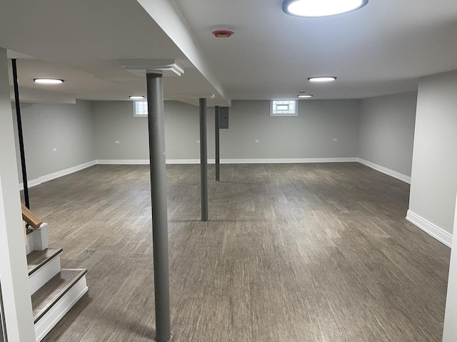 basement with dark hardwood / wood-style floors