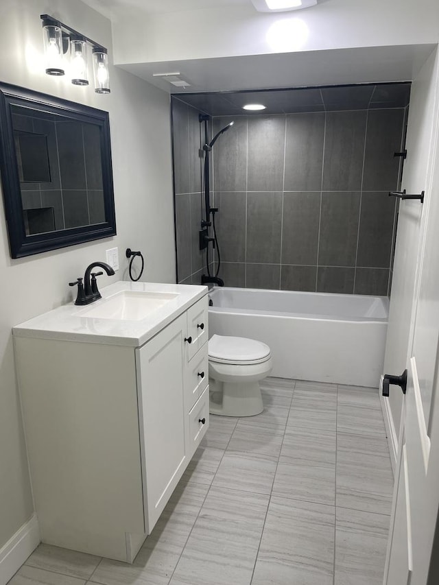 full bathroom featuring vanity, toilet, and tiled shower / bath combo