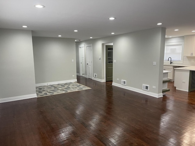 empty room with dark hardwood / wood-style flooring and sink