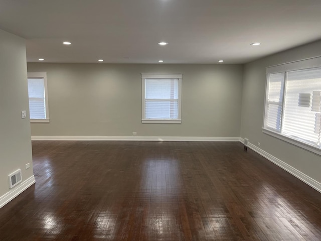 spare room with dark hardwood / wood-style flooring