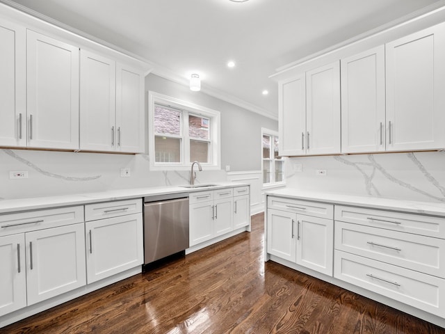 kitchen featuring white cabinetry, stainless steel dishwasher, dark wood-type flooring, and crown molding