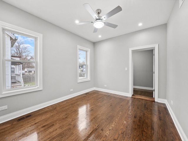 unfurnished room with dark hardwood / wood-style floors and ceiling fan