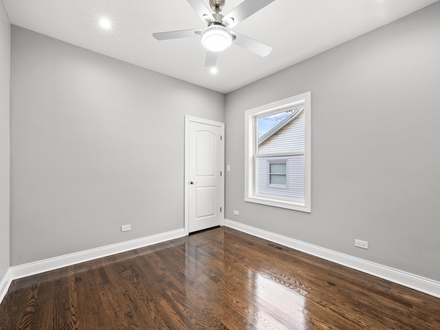 empty room featuring ceiling fan and dark wood-type flooring