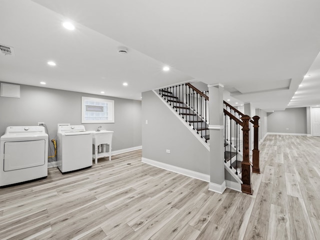 laundry area featuring light hardwood / wood-style floors and washing machine and dryer