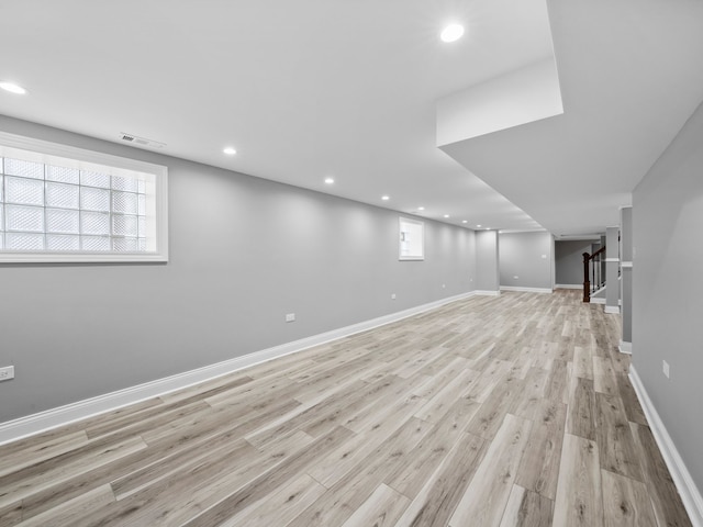 basement featuring light wood-type flooring and a wealth of natural light