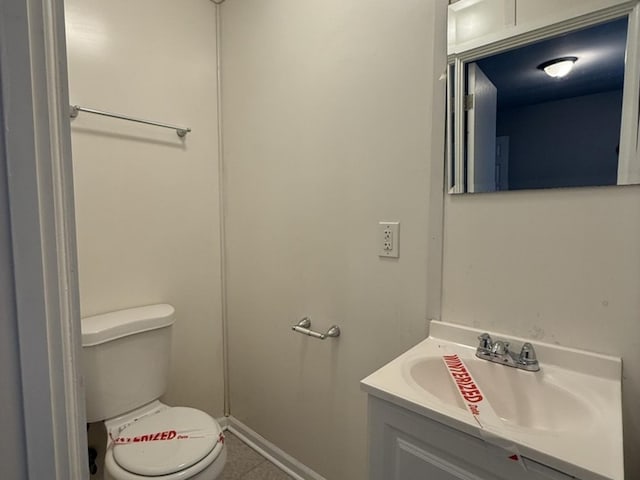 bathroom with tile patterned flooring, vanity, and toilet