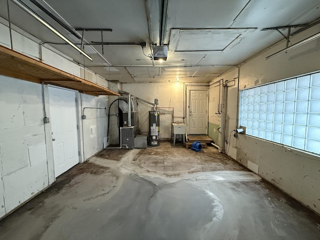 basement with gas water heater, sink, and heating unit