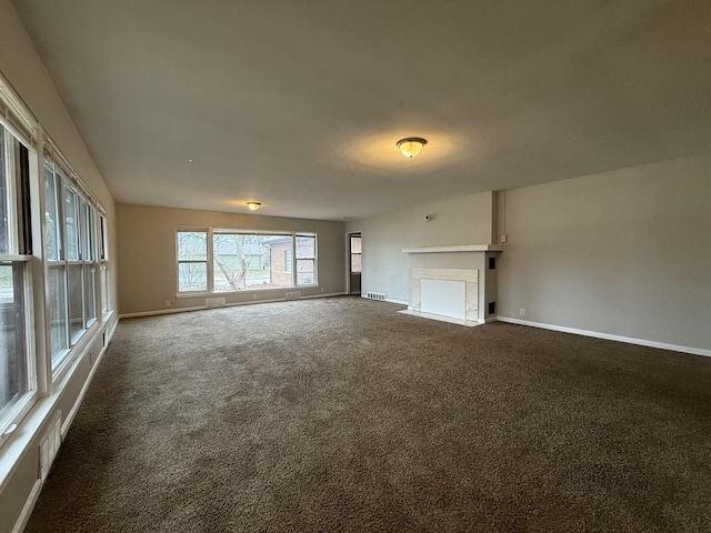 unfurnished living room featuring dark carpet