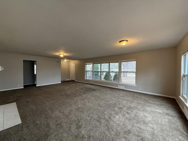 unfurnished living room with dark carpet