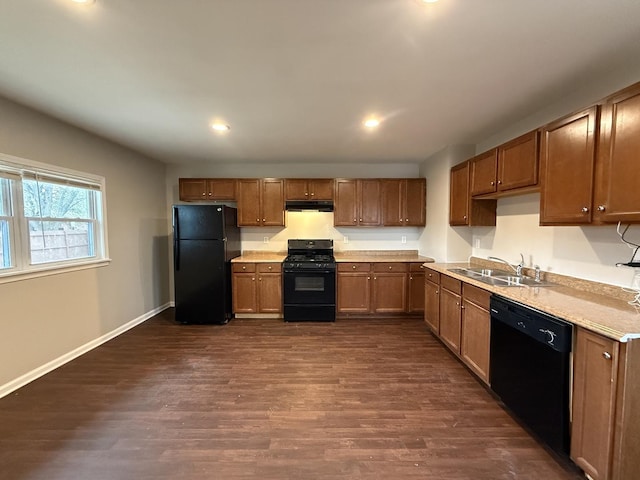 kitchen with dark wood-type flooring, sink, and black appliances