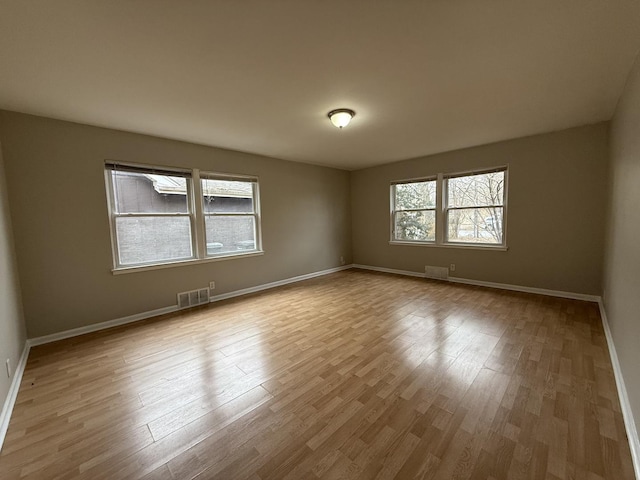 unfurnished room with light wood-type flooring