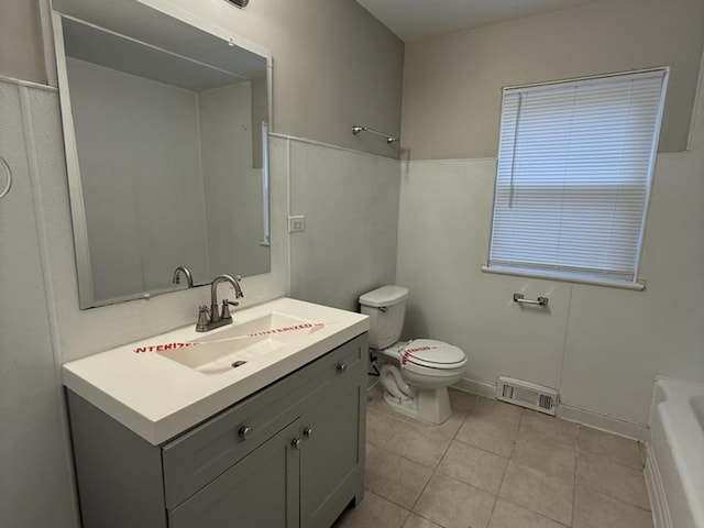 bathroom featuring tile patterned flooring, vanity, and toilet