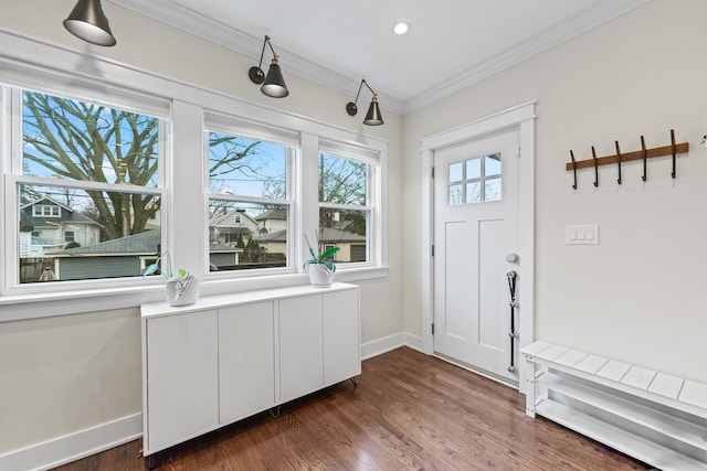 entryway with ornamental molding and dark hardwood / wood-style floors