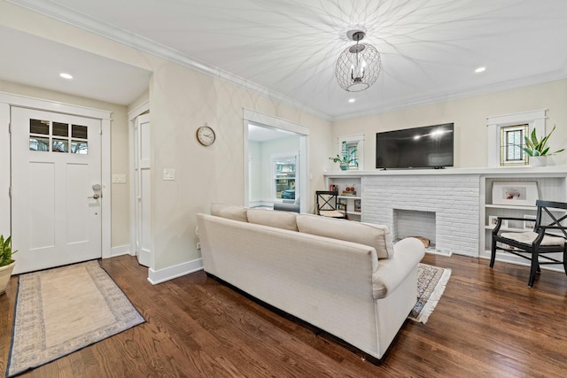 living room with a brick fireplace, dark hardwood / wood-style flooring, and crown molding