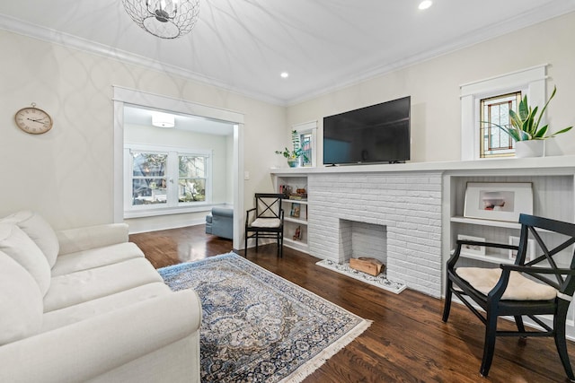 living room with dark hardwood / wood-style floors, plenty of natural light, and a brick fireplace