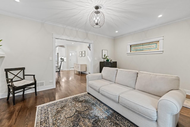 living room with dark wood-type flooring and crown molding