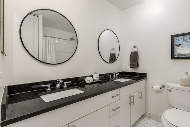 bathroom with vanity, curtained shower, and toilet