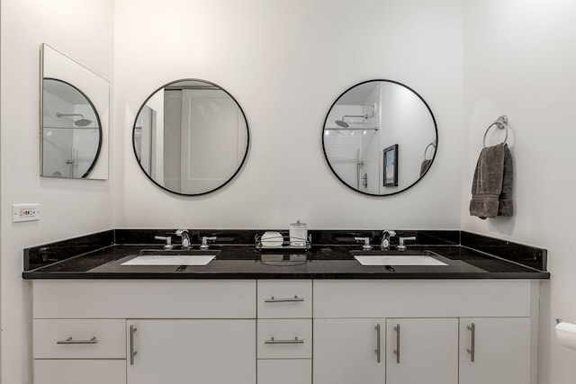 bathroom featuring a shower and vanity