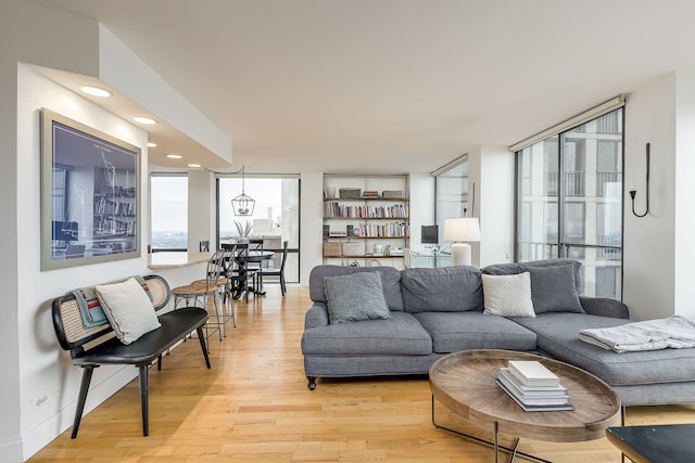 living room with light hardwood / wood-style flooring and floor to ceiling windows