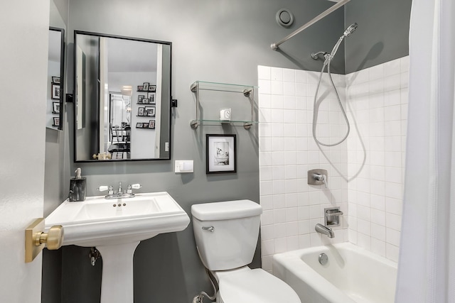 bathroom featuring shower / bath combo and toilet