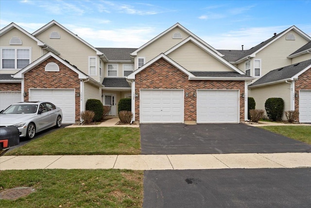 view of front of home with a front yard and a garage