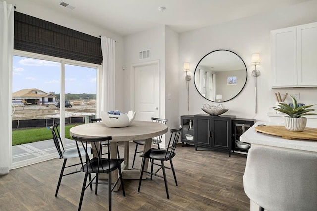 dining space with dark wood-type flooring