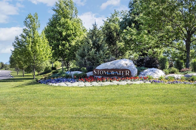 community / neighborhood sign with a yard