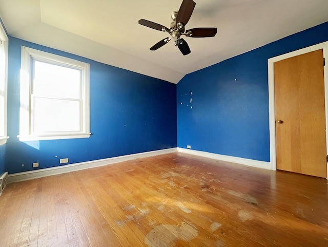 unfurnished room featuring ceiling fan, hardwood / wood-style floors, and lofted ceiling