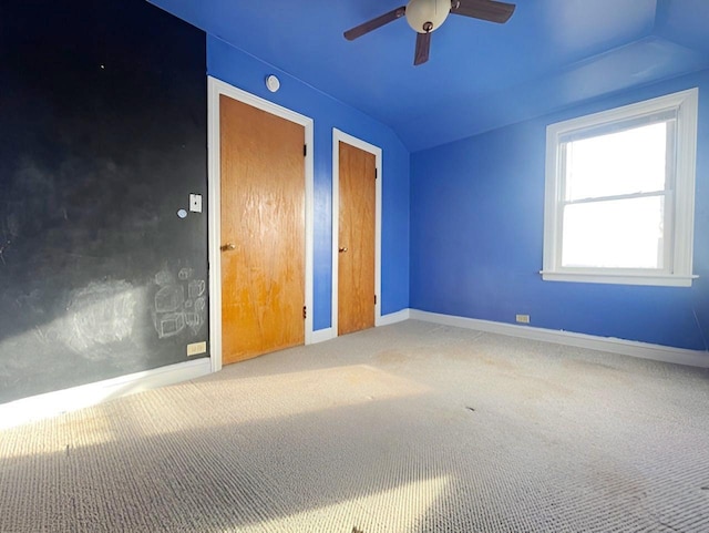 unfurnished bedroom with carpet, ceiling fan, and lofted ceiling