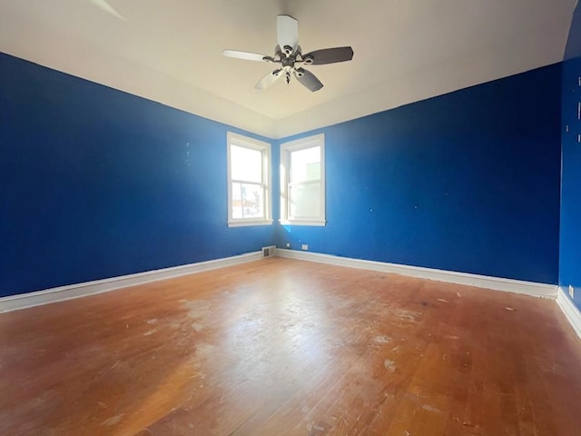 spare room featuring hardwood / wood-style flooring and ceiling fan