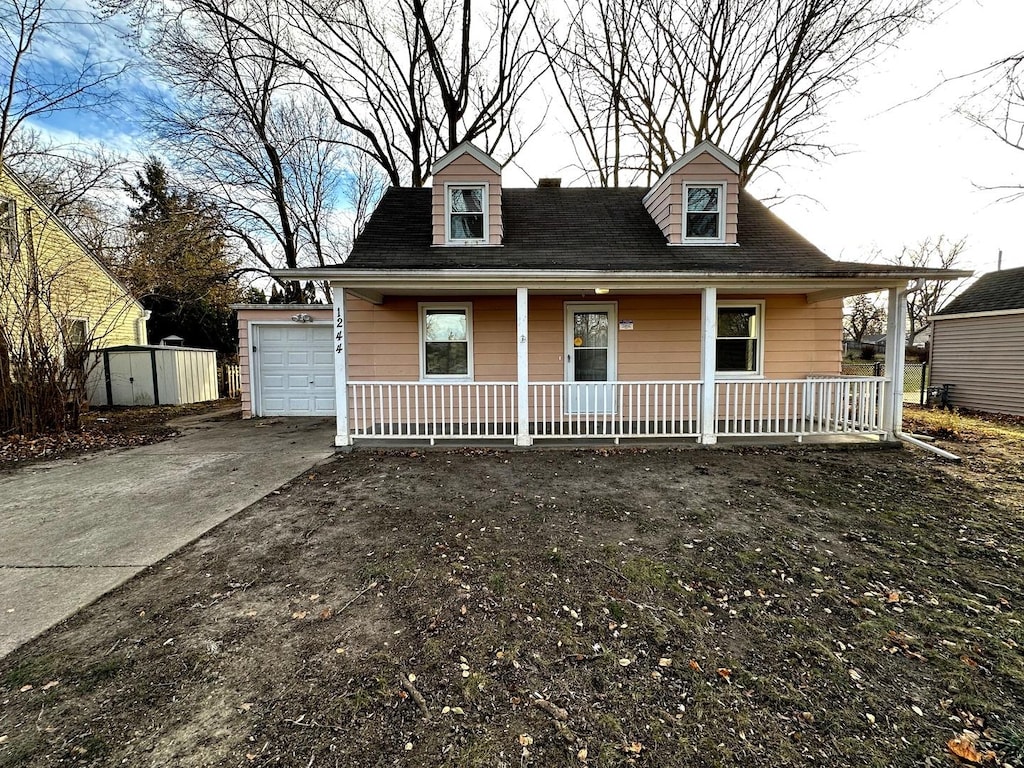 view of front facade with covered porch and a shed