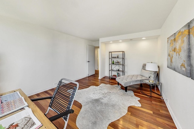 sitting room with wood-type flooring