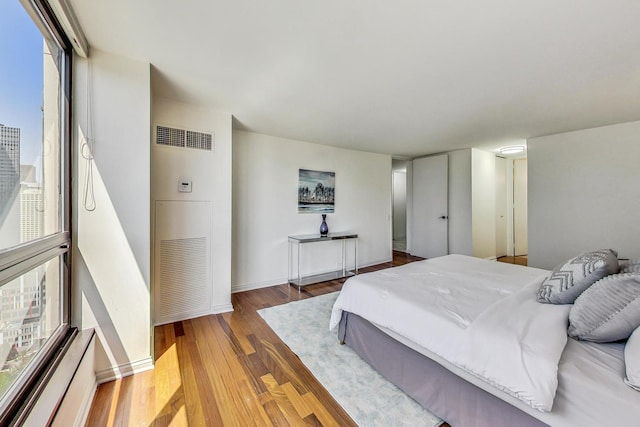 bedroom with hardwood / wood-style flooring