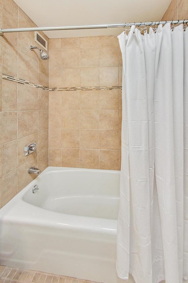 bathroom with shower / bathtub combination with curtain