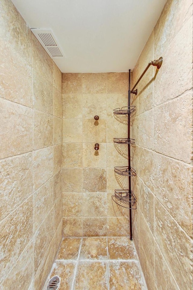 bathroom with a tile shower