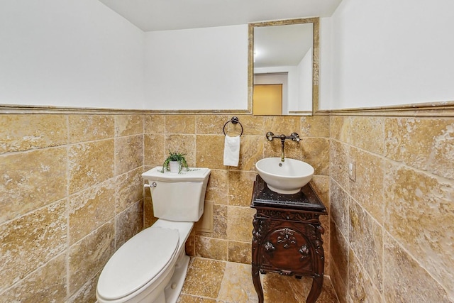 bathroom featuring tile walls, toilet, and vanity