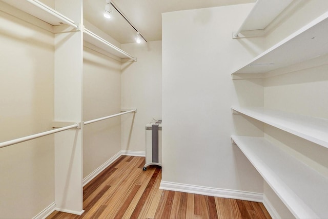 spacious closet featuring light hardwood / wood-style floors