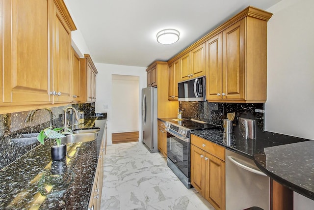 kitchen featuring sink, backsplash, appliances with stainless steel finishes, and dark stone counters