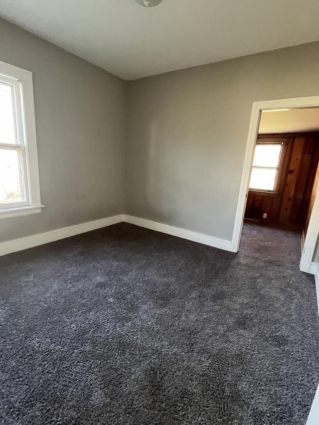 empty room featuring dark colored carpet