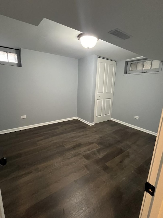 basement with dark hardwood / wood-style flooring