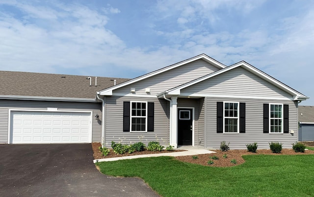 single story home featuring a garage and a front lawn