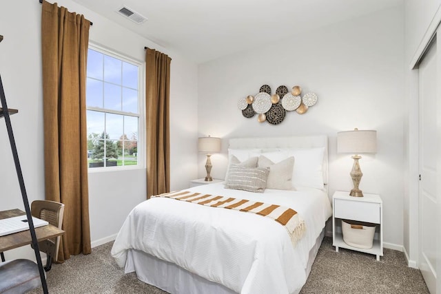 bedroom with dark carpet and a closet