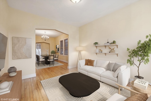 living room with an inviting chandelier and hardwood / wood-style flooring