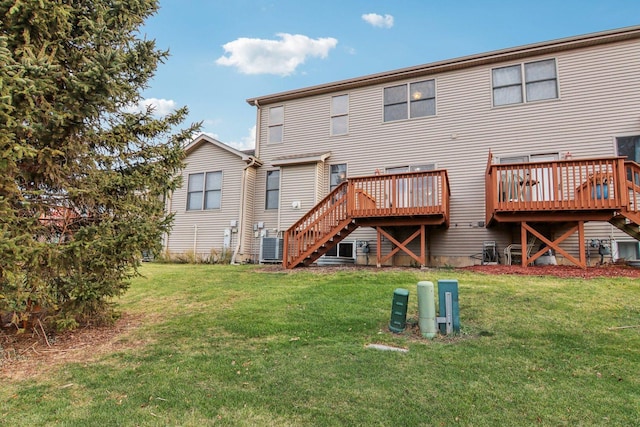 back of property featuring a lawn and a deck