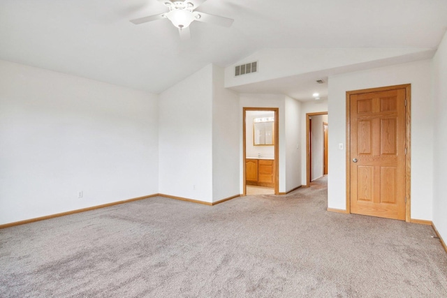 carpeted empty room featuring vaulted ceiling and ceiling fan