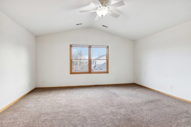 carpeted spare room with lofted ceiling and ceiling fan